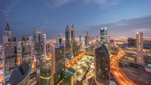 Skyline view of the high-rise buildings on Sheikh Zayed Road in Dubai aerial night to day timelapse, UAE. photo
