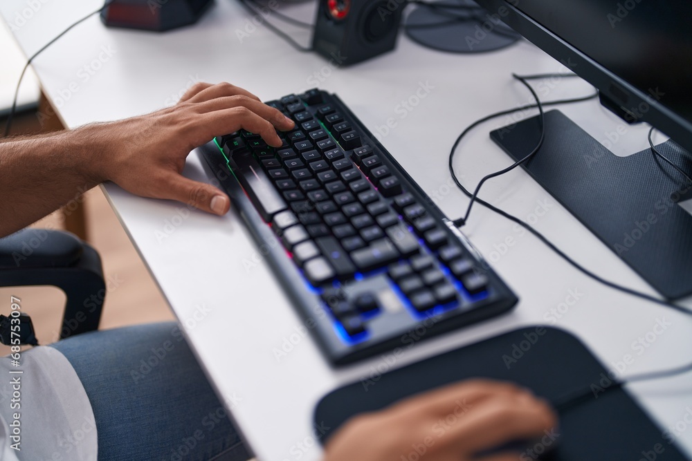 Young hispanic man streamer playing video game using computer at gaming room Young hispanic man streamer playing video game using computer at gaming room