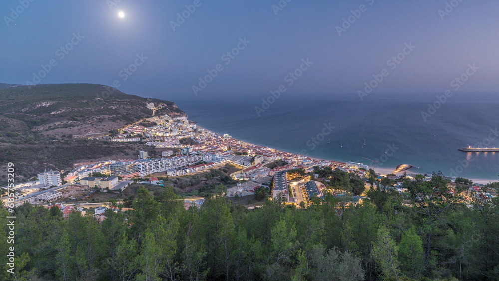 Obraz premium Aerial view of the coastline of the village of Sesimbra day to night timelapse. Portugal