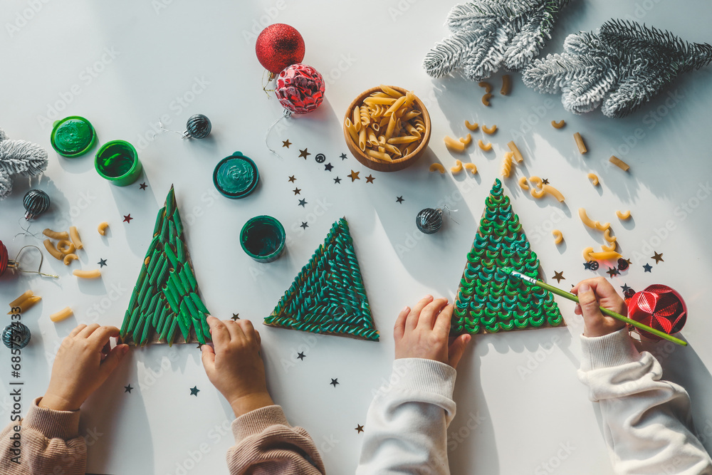 Fototapeta premium Child coloring pasta creativity, Christmas activity idea