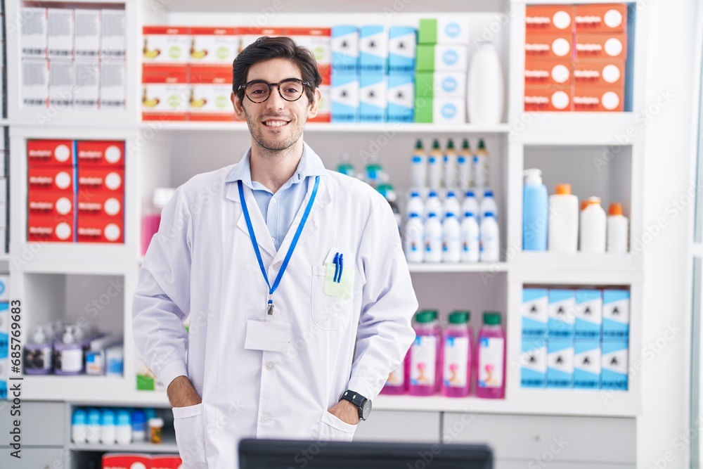 Young hispanic man pharmacist smiling confident standing at pharmacy Young hispanic man pharmacist smiling confident standing at pharmacy