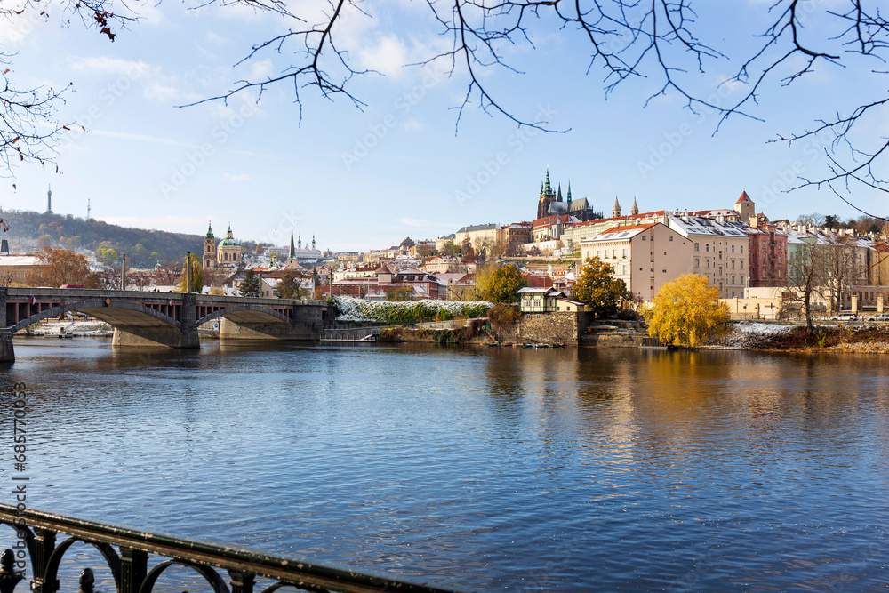 Obraz premium Snowy Prague Lesser Town with Prague Castle above River Vltava in the sunny Day , Czech republic