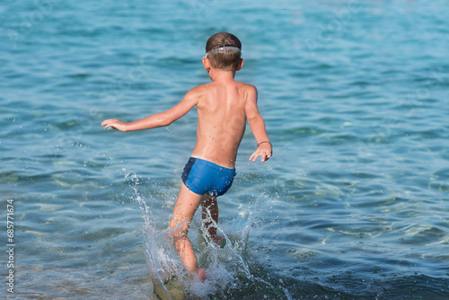 child playing in the sea