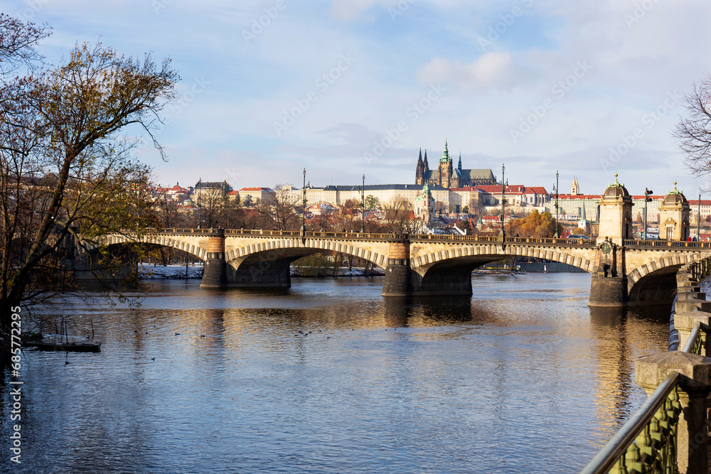 Snowy Prague Lesser Town with Prague Castle above River Vltava in the sunny Day , Czech republic