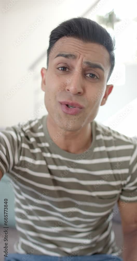 Vertical video of happy emotional biracial man having video call and kissing envelope, slow motion Vertical video of happy emotional biracial man having video call and kissing envelope, slow motion