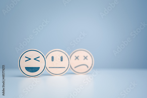 Wooden labels with happy normal and sad face icons for experience survey services and products review concept. Customer or Client choose Good, Neutral, or Negative feedback and satisfaction rating.
