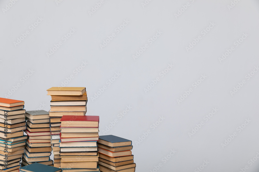 A simple composition of many books, stack or pile of books on wooden table, one of them open with copy space. A simple composition of many books, stack or pile of books on wooden table, one of them open with copy space.