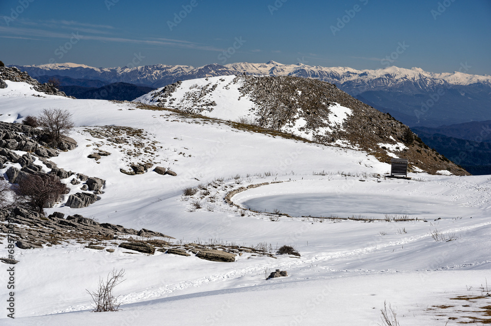 Winter landscape with frozen lake at Mount Avgerinos in Epirus, Greece