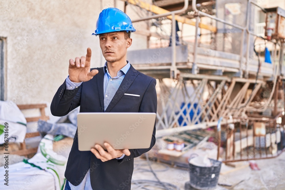 Young man architect using laptop at street Young man architect using laptop at street