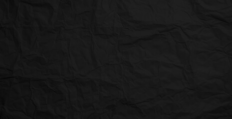 Black crumpled paper texture. Crumpled black paper abstract shape background with space paper for text
