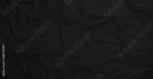 Black crumpled paper texture. Crumpled black paper abstract shape background with space paper for text
 photo