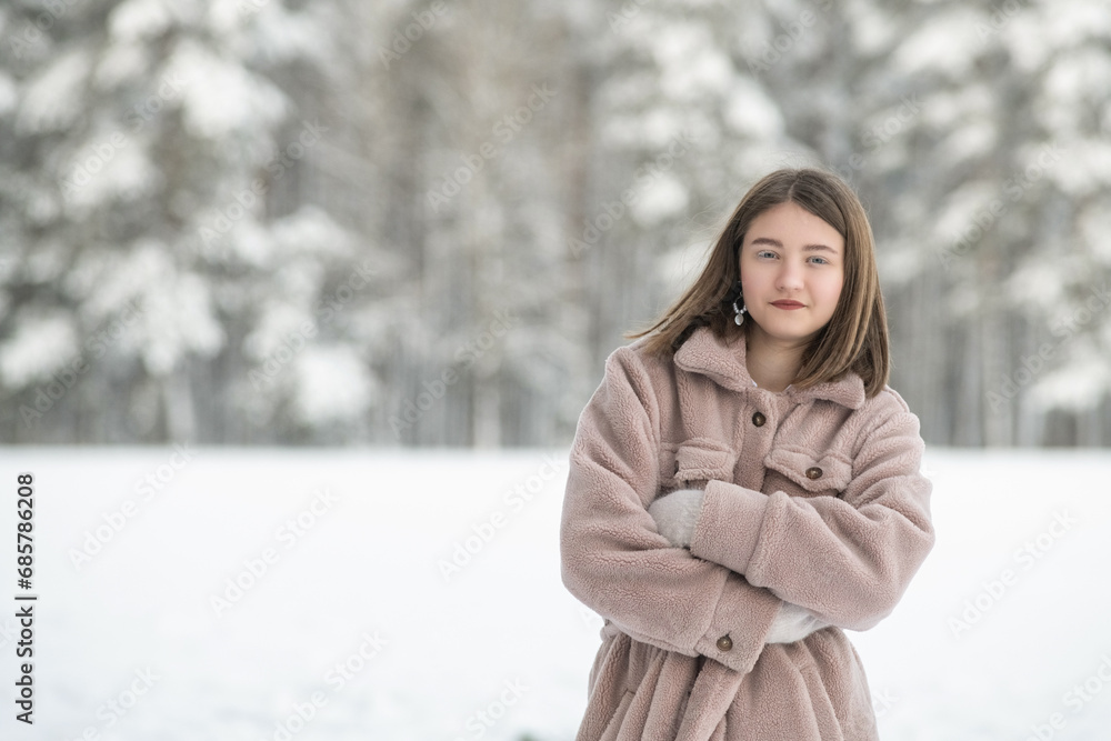 Portrait of a young beautiful girl in a winter forest. Portrait of a young beautiful girl in a winter forest.
