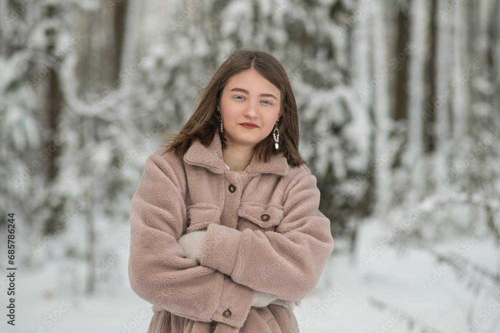Portrait of a young beautiful girl in a winter forest. Portrait of a young beautiful girl in a winter forest.