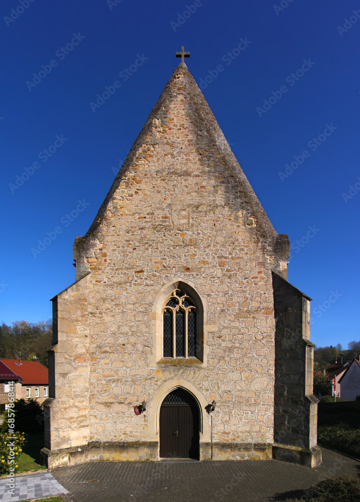 Fototapeta premium Medieval church with symmetrical gothic sandstone facade in the village of Abtweiler, Pfalz region in Germany
