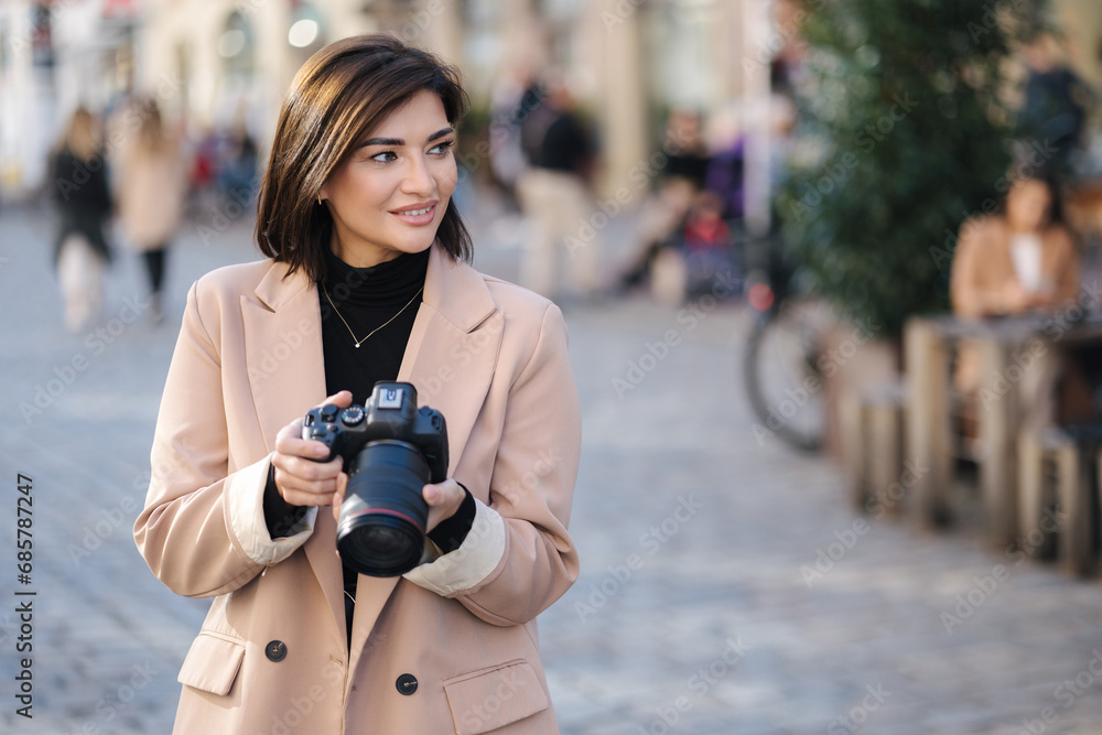 Close-up portrait of professional female photographer hold mirrorless camera. Place for text