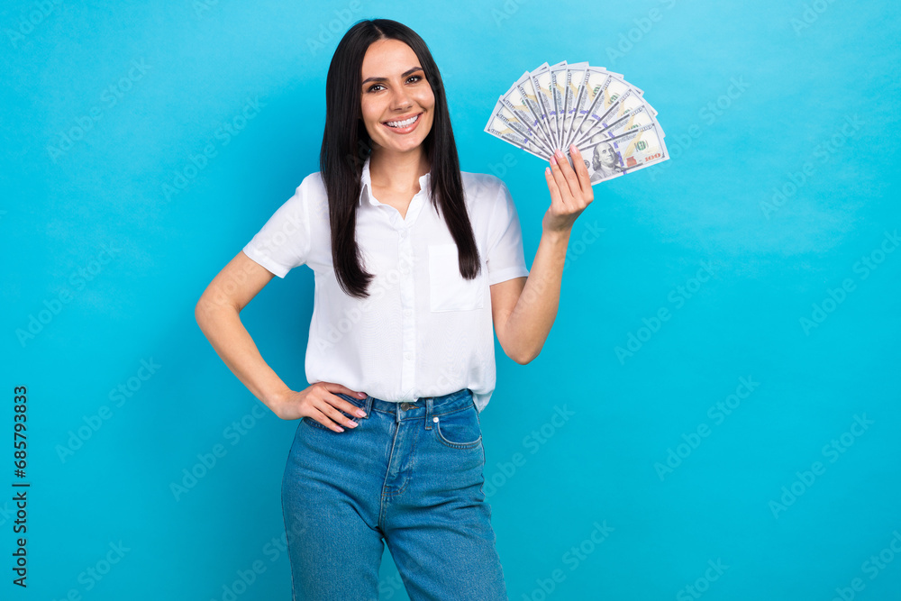 Photo of shiny cheerful girl dressed white shirt smiling rising cash fan isolated blue color background Photo of shiny cheerful girl dressed white shirt smiling rising cash fan isolated blue color background