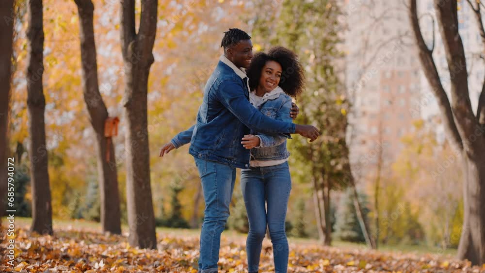 Young black girlfriend and boyfriend hugging in autumn forest Young black girlfriend and boyfriend hugging in autumn forest