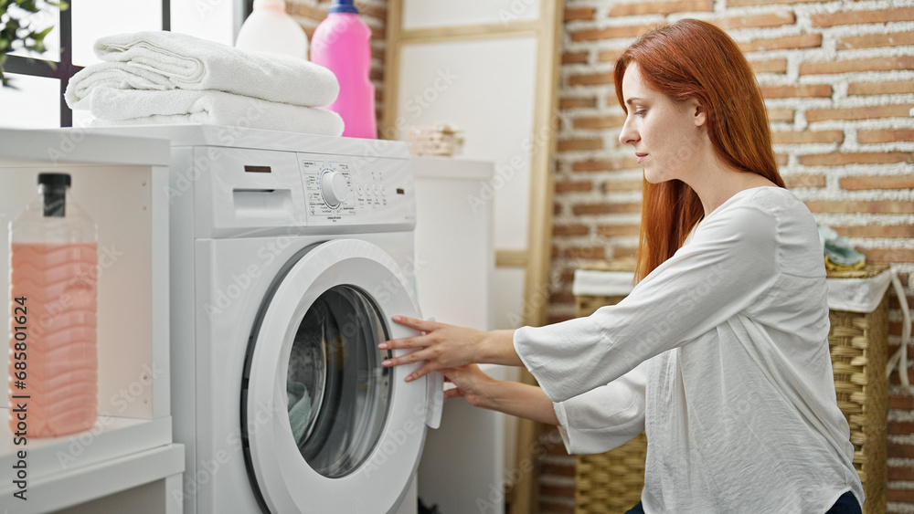Young redhead woman washing clothes at laundry room Young redhead woman washing clothes at laundry room