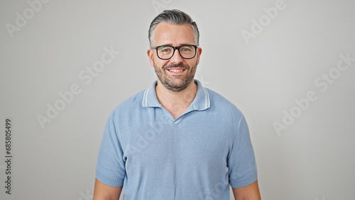 Grey-haired man smiling confident wearing glasses over isolated white background © Krakenimages.com