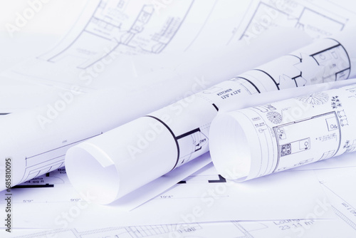 Construction plan. Scheme drawing rolled up in a roll. Home renovation planning.