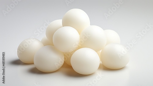 A pile of Rasgulla, soft and spongy, set against a solid white background to emphasize its simplicity and deliciousness.