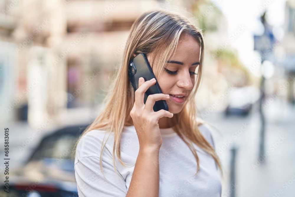 Young blonde woman smiling confident talking on the smartphone at street Young blonde woman smiling confident talking on the smartphone at street