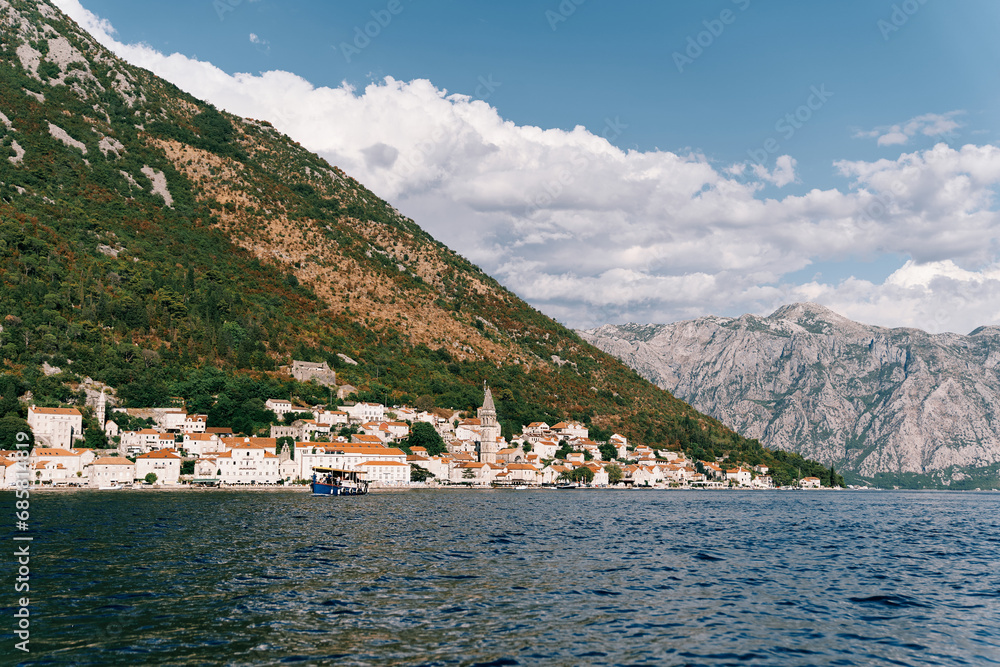 Excursion boat sails along the Bay of Kotor along the coast of Perast. Montenegro