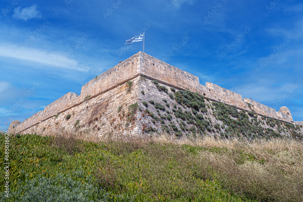 National Greek flag fluttering from the Venetian Fortezza Castle, Rethymno, Crete, Greece