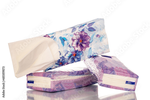 Three packs of paper handkerchiefs, close-up, isolated on white background.
