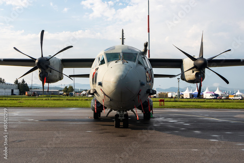 Untitled military transport plane at air base. Airport and airfield. Air force and army flight operation. Aviation and aircraft. Air lift. Military industry. Fly and flying.