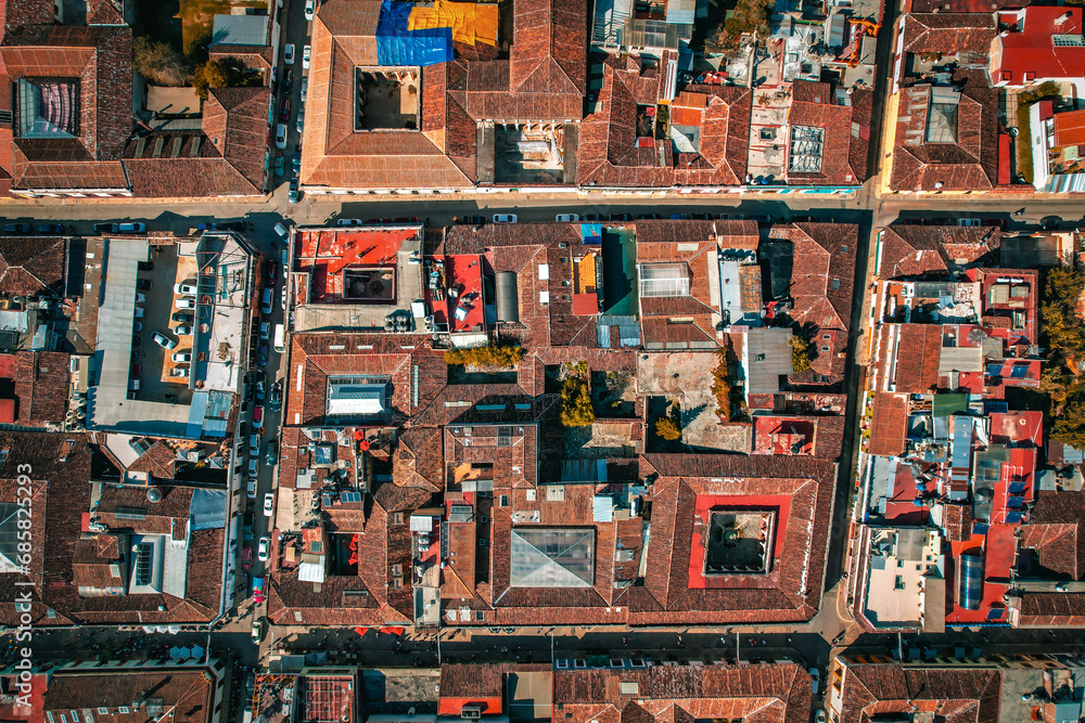 
Aerial perspective reveals a charming Mexican square, surrounded by colonial architecture, a historic panorama unfolds.