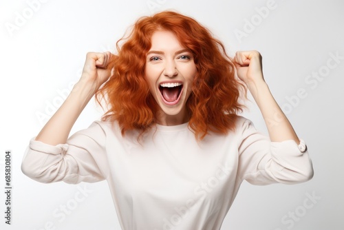 Energetic Redhead Spreading Joy And Positivity On The Background Of White Wall