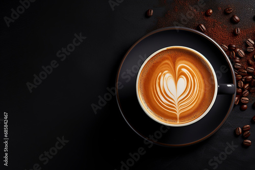 Cup of coffee latte with heart shape and coffee beans on dark background. Cup of fresh made coffee on dark background. Top view, copy space.