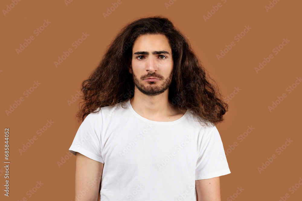 Studio Portrait Of Sad Arabic Guy With Long Curly Hair Studio Portrait Of Sad Arabic Guy With Long Curly Hair