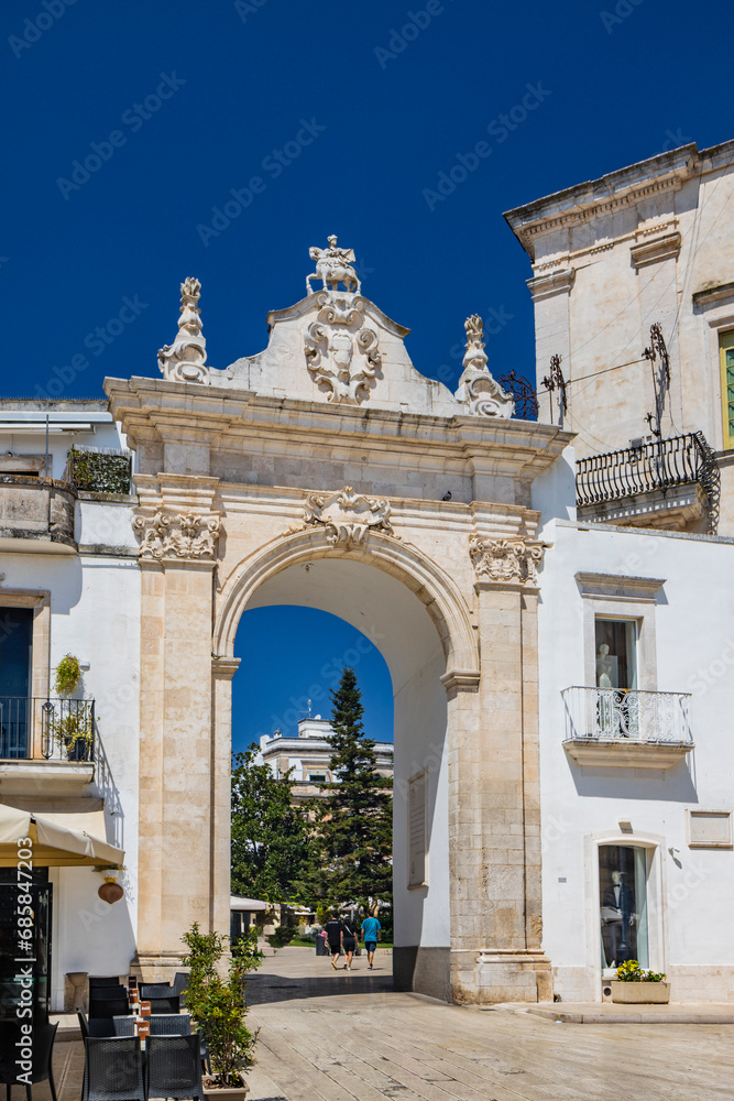Martina Franca, Taranto, Puglia, Italy. Village with baroque architecture. The Santo Stefano Gate gives access to the city center. Sunny day in summer.