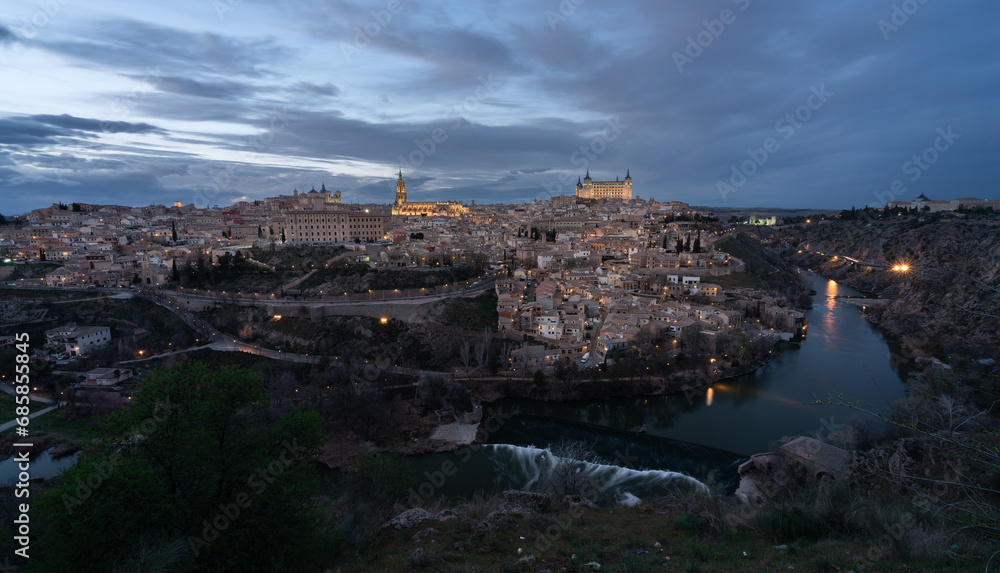 Historic city of Toledo with the a weir of Tagus River in foreground from a viewpoint of the city in the evening. UNESCO World Heritage Site