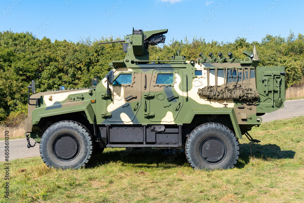 A camouflaged modern 4x4 MRAP armored fighting vehicle A camouflaged modern 4x4 MRAP armored fighting vehicle