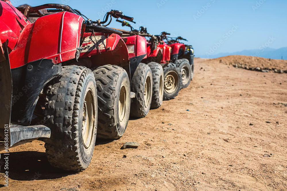 Red quads stand in a row on the shore of the Red Sea. Dahab, Egypt. Red quads stand in a row on the shore of the Red Sea. Dahab, Egypt.
