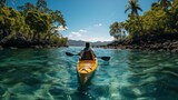 man paddling kayak on tropical island