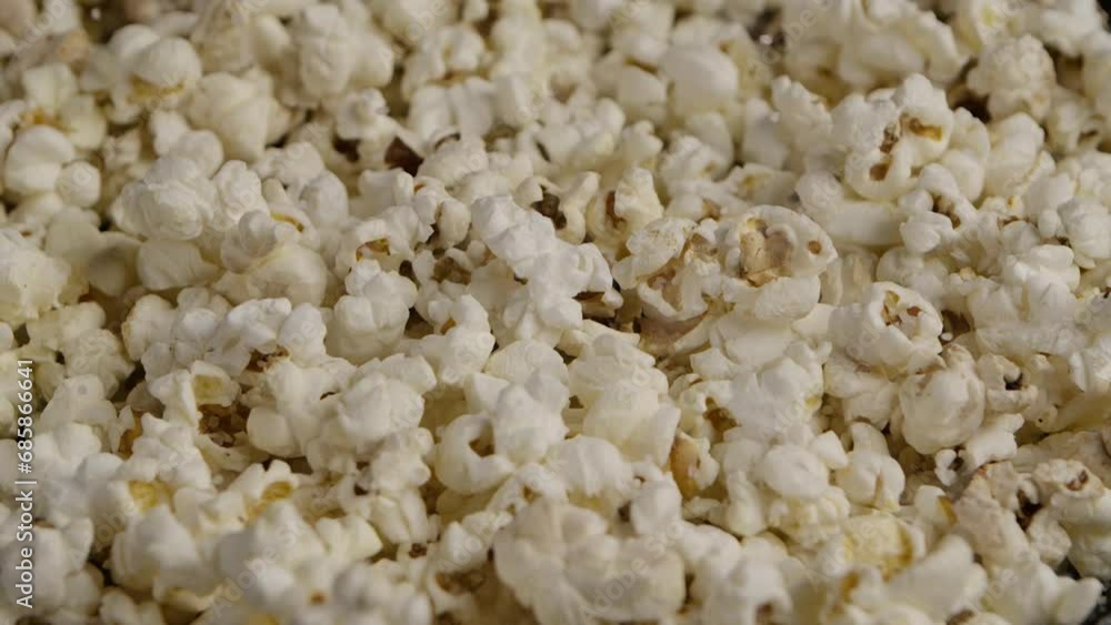 Sprinkling salt on popcorn. Slow Motion. Macro shot. Sprinkling salt on popcorn. Slow Motion. Macro shot.