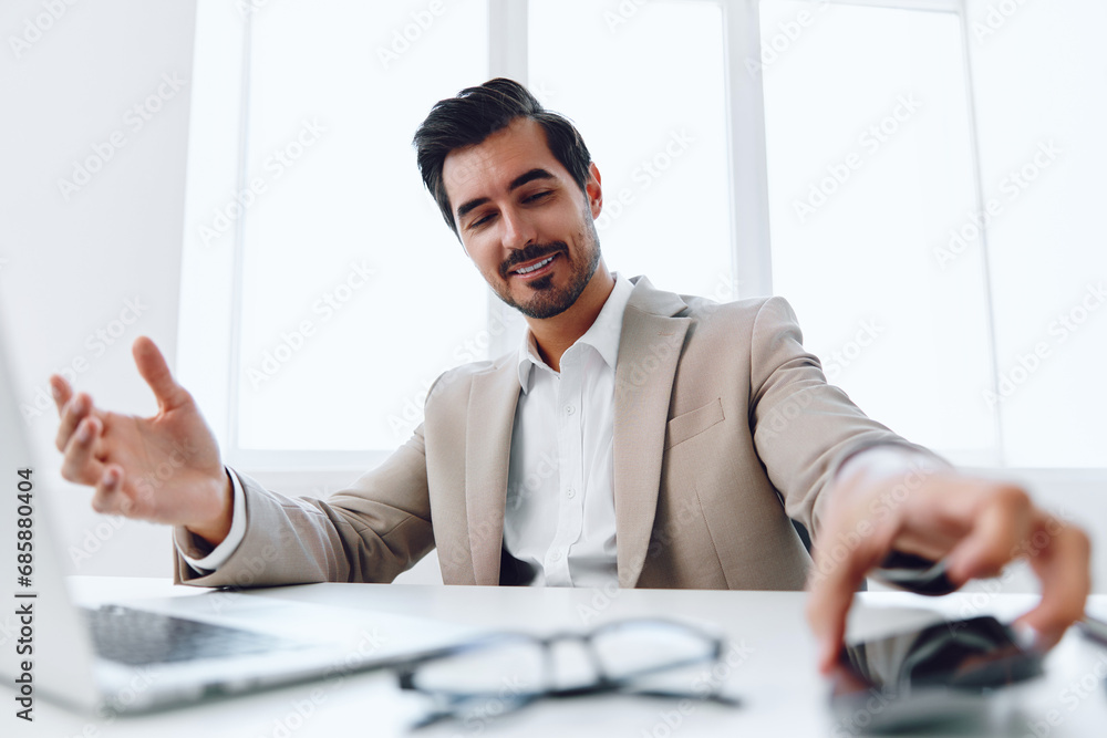 Man in office businessman sitting at desk and working in laptop and talking on phone, modern suit, finance and startup concept and data analysis, working lifestyle in bright office. Man in office businessman sitting at desk and working in laptop and talking on phone, modern suit, finance and startup concept and data analysis, working lifestyle in bright office.