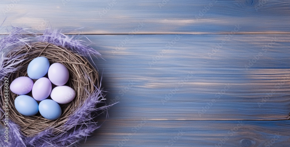 Pastel purple and blue Easter eggs in a nest on the wooden rustic background. Top view spring backdrop with copy space.