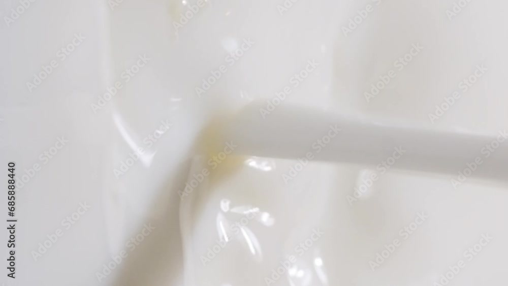 Slow motion of pouring milk. Vertical video Slow motion of pouring milk. Vertical video