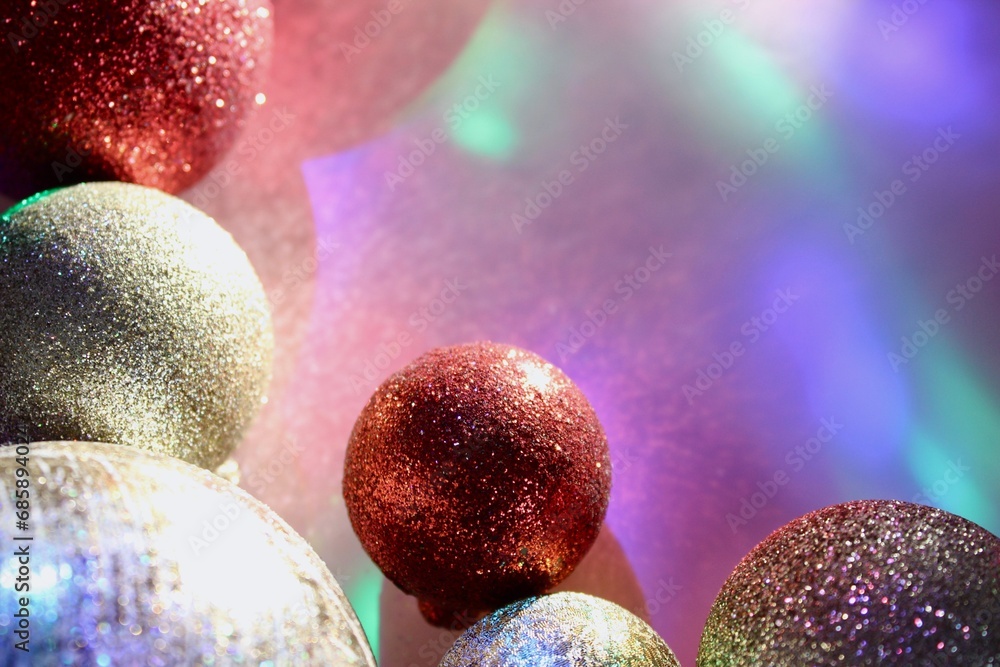 christmas balls on a background of colored lights and bokeh.