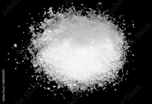 Pile of white snow isolated on a black background.