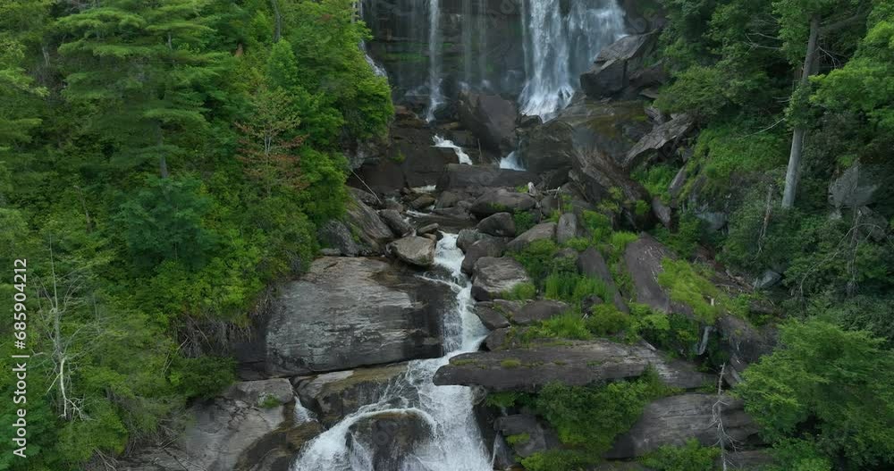 Whitewater Falls with falling down clear water from rocky boulders between green lush woods in Nantahala National Forest, North Carolina, USA Whitewater Falls with falling down clear water from rocky boulders between green lush woods in Nantahala National Forest, North Carolina, USA
