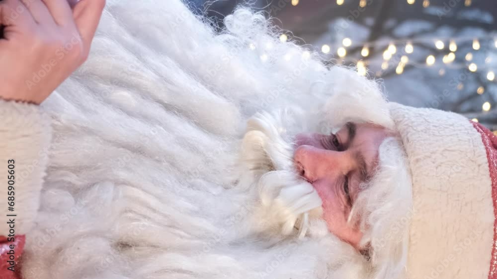 Santa Claus is using a smartphone. Vertical video Santa Claus is using a smartphone. Vertical video