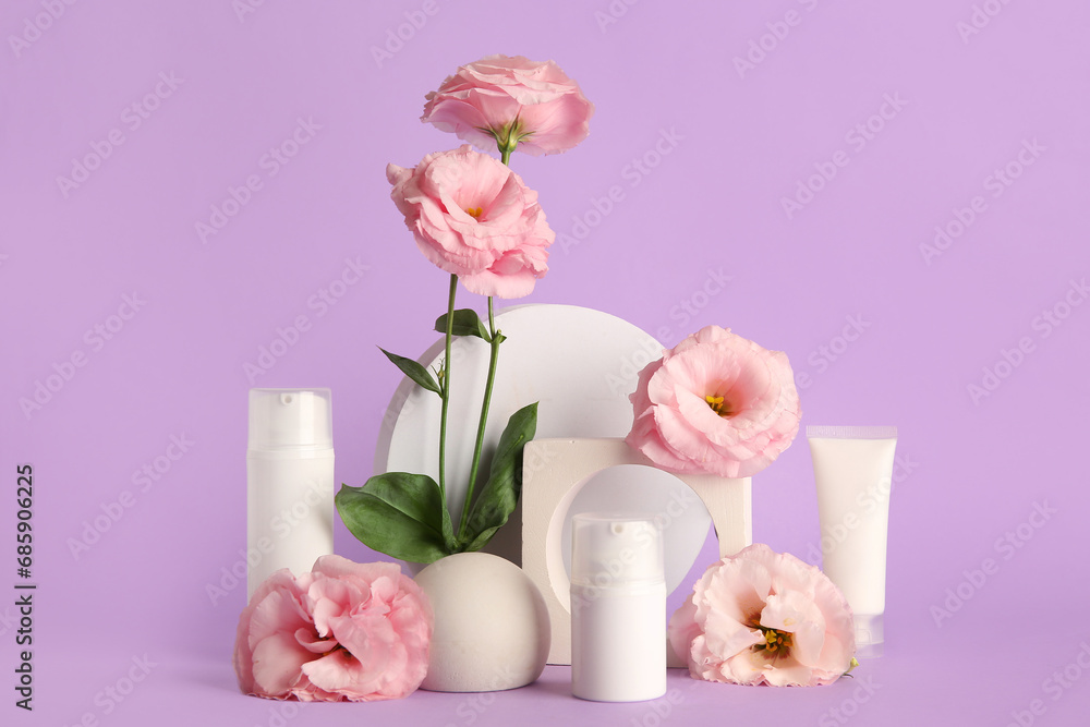 Composition with different cosmetic products, plaster podium and beautiful eustoma flowers on purple background