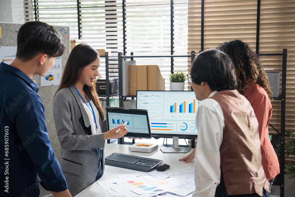 Asian Creative business team presents business profits to colleagues at meeting room in office. Asian Creative business team presents business profits to colleagues at meeting room in office.