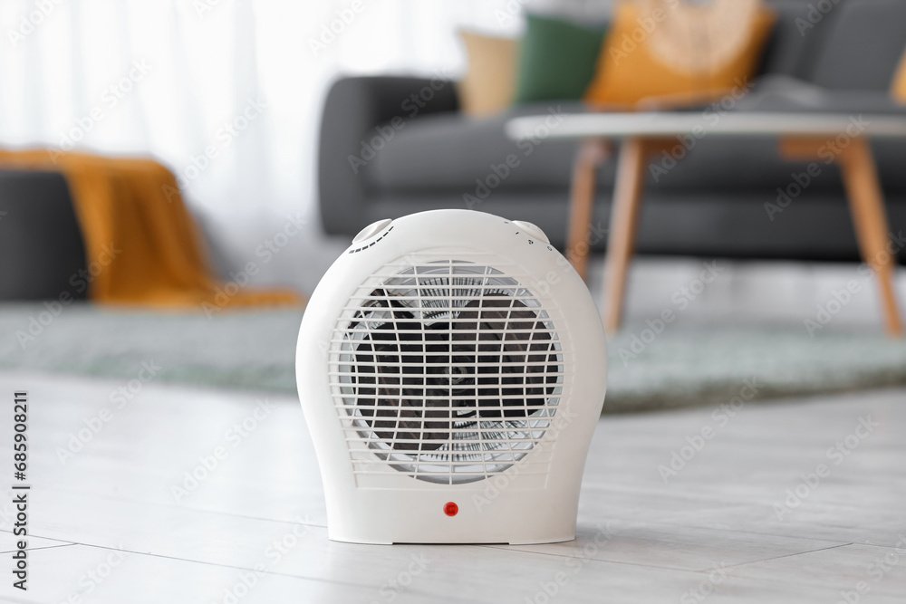 Electric fan heater on floor in living room